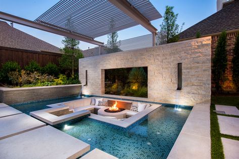 This modern and luxurious swimming pool has a spa with a fireplace, a sunken lounge with a firepit, a cantilevered deck, and floating stepper pads. #SwimmingPool #PoolDesign #LandscapingIdeas #PoolIdeas Sunken Fire Pit, Patio Seating Arrangement, Sunken Patio, Sunken Fire Pits, Terrasse Design, Luxury Pools, Modern Pools, Pool Lounge, Modern Backyard