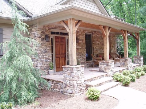 Stacked stone -- to replace brick on exterior. Stacked stone column bases. Also like the shingles above. No on the rustic columns. Rustic Porch Ideas, Front Porch Stone, Front Porch Columns, Rustic Front Porch, Front Porch Railings, Porch Kits, Porch Remodel, Wood Columns, Building A Porch