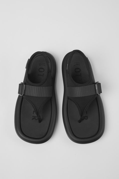 Black recycled neoprene men's sandals by Camper x Ottolinger with XL EXTRALIGHT® Organix™ 3.0 outsoles (with 30% bio-circular compounds). Berlin-based womenswear label Ottolinger is a collaboration between Swiss-born designers Christa Bösch and Cosima Gadient. Their avant-garde designs showcase the duo's fearlessly destructive approach to luxury fashion’s status quo. Established in 2016, Ottolinger’s creations subvert traditional notions of textural and deconstructive applications, characterized by carefully considered detailing and labor- intensive hand work like burning, lacerating, dipping, dying, and ripping Camper Store, Old Shoes, Status Quo, Hand Work, Mens Spring, Women's Sandals, Mens Sandals, Showcase Design, Black Sandals