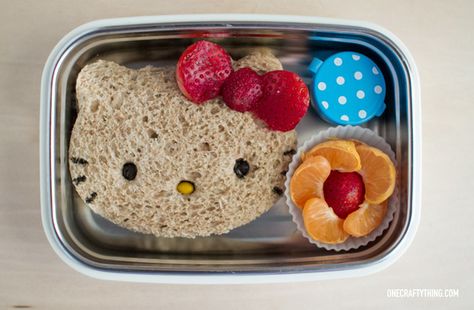 Ok I admit it -- I got a Hello Kitty sandwich cutter and I absolutely HAD to use it. It helps that my kiddos are deep in the love of all things Hello Kitty so this one is a no-brainer. Sandwich PB&J on whole wheat. Strawberry flower bow (I cut a large strawberry in half… Hello Kitty Sandwich, Hello Kitty Food, Kotak Bento, Fun Kid Lunch, Kids Lunch Box Meals, Bento Box Lunch For Kids, Healthy School Lunches, Fun Lunch, Think Food