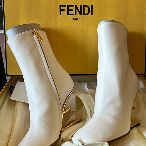 Fendi First Ankle Boots With A Tapered Toe And Inside Side Zipper With Fendi O’lock Ring. Made Of White Leather. Sculpted Diagonal F-Shaped Heel In Gold-Colored Metal. Made In Italy Composition 100% Calf Leather, Inside: 100% Goat Leather Measurements Heel Height : 95 Mm New, Never Worn.