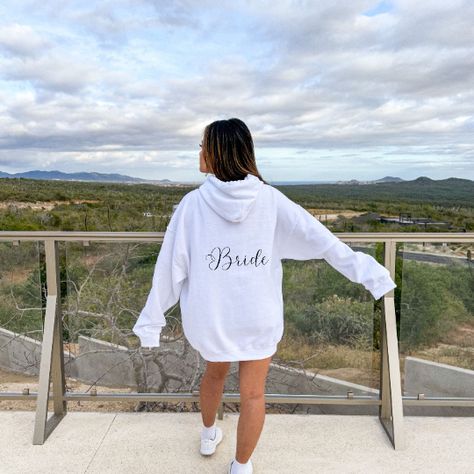 This bridal hooded sweatshirt with your custom date is a must have for your upcoming wedding! Made with a thick blend of cotton and polyester, it feels plush, soft and warm. - 50% cotton, 50% polyester - Runs true to size - Medium-heavy fabric - Both soft and stylish **Model is wearing XL for oversize look** **Bride Hoodie matches with our Bride Squad Hoodie found on our store** Make sure to rate us and enjoy! Bride Hoodie Sweatshirts, Bridal Hoodies, Wedding Hoodie, Bride Hoodie, Hoodie Customize, Bride Squad, Wedding Date, Oversize Hoodie, Cold Day