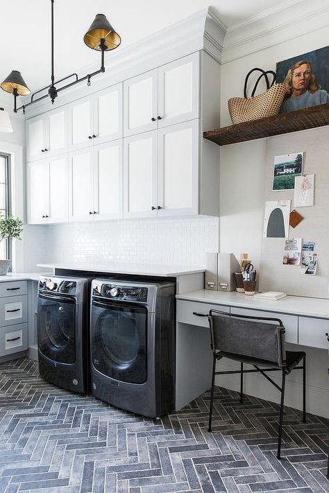 Stacked laundry room cabinets finished in white and gray bring a two-toned design styled with a home office extension. Stacked Laundry Room, Basement Laundry Room, Basement Laundry, Laundry Room Remodel, Laundry Room Cabinets, Room Renovation, Laundry Room Storage, Laundry Mud Room, Studio Mcgee