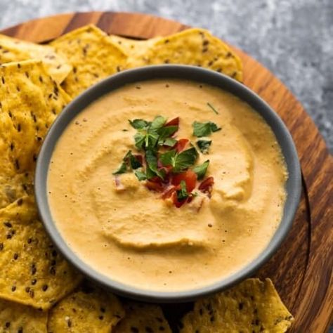 bowl of cashew queso topped with tomatoes and cilantro surrounded by chips Healthy Office Snacks, Cashew Queso, Sweet Peas And Saffron, Queso Recipe, Meal Prep Snacks, Chunky Salsa, Savory Pies, Roasted Cashews, Raw Cashews