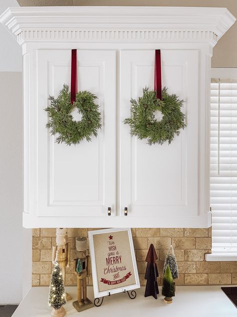 Mini Cedar Christmas Wreath Set with Burgundy Velvet Ribbon Kitchen Wreaths Cabinets, Christmas Wreaths On Cabinets, Kitchen Cabinet Wreaths Christmas, Small Wreaths On Cabinets, Wreaths On Cabinet Doors, Christmas Cabinets Decorating Ideas, Kitchen Cabinet Christmas Decor, Wreaths On Kitchen Cabinets, 3 Wreaths