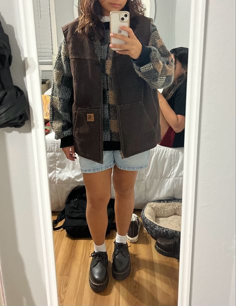 mirror picture. brown carhartt best. grandpa sweater. doc martnes. jorts How To Style A Sweater Vest Fall, Carhartt Women Outfits Fall, Outfits With Carhartt Vest, Carhartt Gilet Outfit, How To Style Brown Doc Martens, Light Brown Vest Outfit, Women’s Carhartt Vest Outfit, Carhartt Outfit Aesthetic, Brown Sherpa Vest Outfit