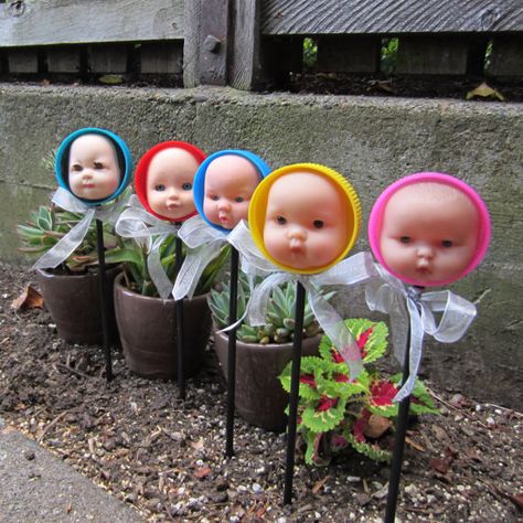 Doll head plant markers. | 29 Gifts To Buy The Weirdest Person You Know Creepy Baby Dolls, Plastic Bottle Caps, Jeff Koons, Plant Markers, Plastic Caps, Doll Art, Creepy Dolls, Doll Parts, Plastic Bottle