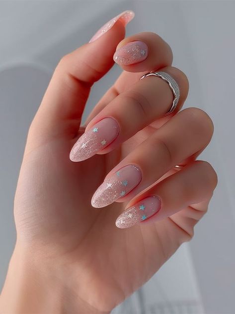 This delicate and dreamy nail art design blends soft pink with glitter accents, topped with charming moon and star details. The translucent gradient and subtle sparkles make this design whimsical yet elegant, perfect for a magical and ethereal touch to your nails. Subtle Star Nails, Ethereal Nails, Dreamy Nail, Colorful Nail Designs, Star Nails, New Year's Nails, Moon And Star, Pink Glitter, Nail Art Design