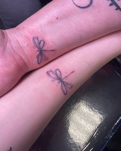 Dragonfly symbolizes wisdom, change, light and adaptability in life Dragonfly Tattoo Matching, Dragonfly Friendship Tattoo, Two Dragon Fly Tattoo, Symbolic Mother Daughter Tattoos, Tattoo Idea Mother Daughter, Simple Mom Daughter Tattoos, Dragonfly Matching Tattoos, Dragonfly Tattoo On Hip, Single Line Dragonfly Tattoo