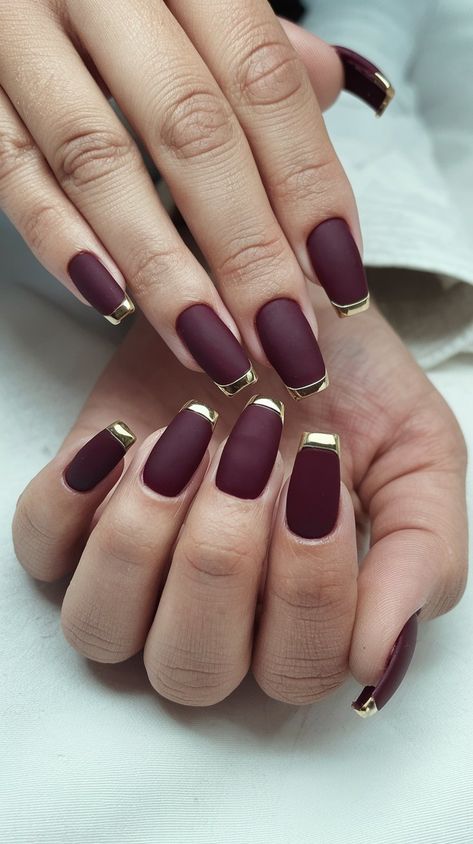 Embrace the elegance of autumn with this stunning matte burgundy manicure! Featuring glamorous gold tips, these nails are the perfect blend of sophistication and seasonal flair. Whether you’re dressing up for a special occasion or just want to elevate your everyday look, this nail design will make a statement. Get inspired to try this trendy style! #NailInspiration #FallNails #septembernails #BeautyTrends Fall Nails Maroon And Gold, Matte Burgundy Nails With Gold, Maroon Nails With Gold, Burgundy Gold Nails, Fall Transition Nail Colors, Burgundy Nails With Gold, Matte Burgundy Nails, Burgundy And Gold Nails, Burgundy Manicure