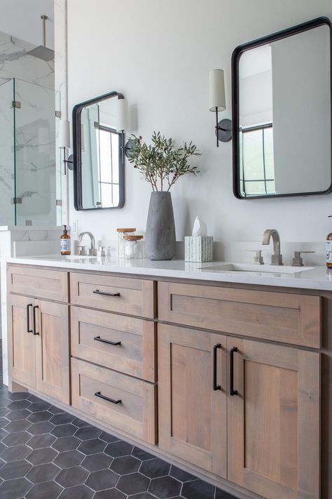 Wood vanities and a black hexagonal tile floor set this bathroom apart from a more basic neutral look. See the pretty room at HGTV.com. Makeover Kamar Mandi, Lake House Bathroom, Black Floor Tiles, Moore House, Wood Bathroom Vanity, Transitional Bathroom, Master Bath Remodel, Bathroom Remodel Designs, Up House