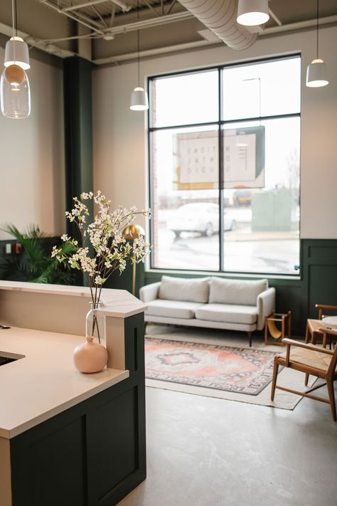 Dental office waiting room in Nashville, TN. #concrete floors #open ceiling #wainscoting #modern #green walls #living room ideas #layered rugs #midcentury Olive Green Dental Clinic, Modern Farmhouse Waiting Room, Boho Commercial Office, Cute Waiting Room Ideas, Mid Century Waiting Room, Dr Office Waiting Room, Boho Office Waiting Room, Drs Office Waiting Room, Doctor Office Waiting Room Decor