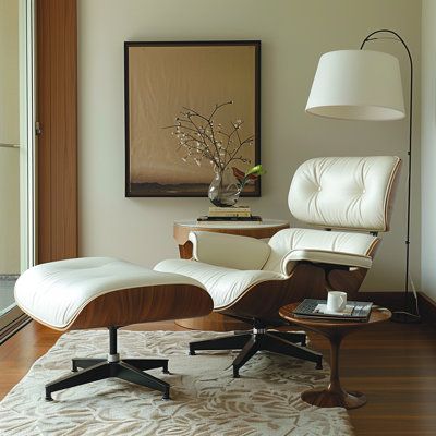 Featuring a sleek solid wood frame and top-grain genuine leather upholstery, this chair offers an ergonomic design with a deep seat, wide armrests, and a 110-degree tilt for unparalleled relaxation. Meticulously crafted with options in light walnut, dark walnut, or rosewalnut veneers, and supported by a die-cast aluminum swivel base, it provides both durability and elegance. Complete with a matching ottoman, the Lounge Chair enhances any living room, study, or executive office with its sophistic Leather Lounge Chair With Ottoman, Living Room With Leather Recliner, Vintage Recliner Chair, Eames Lounge Chair Living Room Interiors, Chair And Ottoman Living Room, Modern Swivel Chair Living Room, Bedroom Lounge Area Ideas, Eames Chair Living Room, Leather Reading Chair