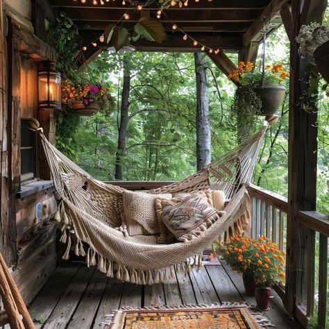 Relaxing outdoor hammock surrounded by hanging flowers and warm lighting, perfect for unwinding in nature. Hammock Front Porch, Porch With Hammock, Porch Hammock, Woven Hammock, Room Hammock, Net Hammock, Indoor Hammock, Hanging Chair Outdoor, Enclosed Porches