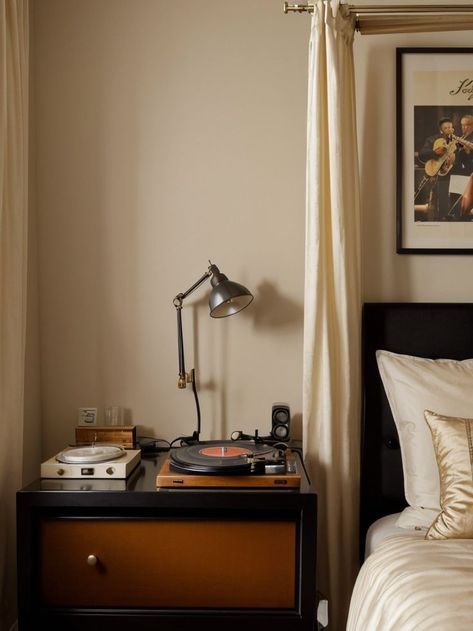 Create a vintage jazz aesthetic for your bedroom by incorporating a vinyl record player as a bedside table. Hang a large poster featuring iconic jazz musicians and drape a velvet curtain behind your bed for a glamorous touch. Vintage Jazz Aesthetic, Jazz Bedroom, Jazz Aesthetic, Vinyl Record Player, Jazz Musicians, Velvet Curtains, Large Poster, Record Player, Aesthetic Bedroom