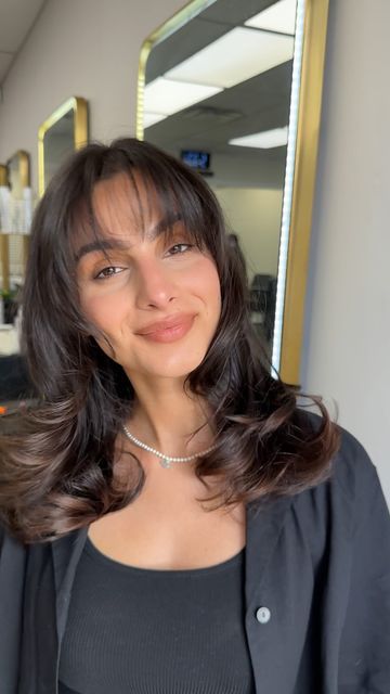 Amanpreet Dhandwar on Instagram: "Wispy bangs for the win✨ Navi wanted more volume and shorter curtain bangs that compliment her face shape! Products: @unite_hair elevate mousse @unite_hair smooth and shine @milbonusa texture spray #volume #bouncyhair #bangs #blowout #aesthetic #faceframe #brunette #hairgoals #hairsandstyle #hairsalon #brampton"