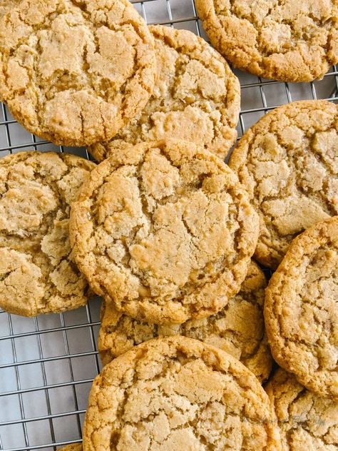 Stacked cookies on a cooling rack. English Toffee Cookies Recipes, English Toffee Bits Recipes, Toffee Chip Cookies Recipe, Chewy Toffee Cookies, Cookies Using Toffee Bits, Chocolate Chip Toffee Cookies Recipes, Heath Bar Bits Recipes, White Chocolate Toffee Cookies, Toffee Crunch Cookies