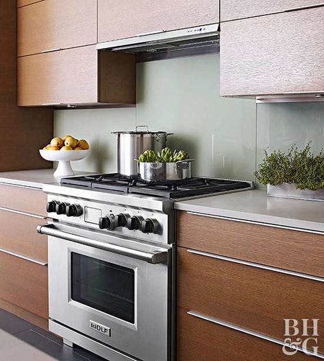 Fewer details keep a kitchen feeling calm and clutter-free, but the modern look doesn't have to be cold. This kitchen combines cloudy gray granite counters, glass backsplashes, and hardware so slim it barely registers. Mingle the backsplash idea with large expanses of riftsawn oak cabinetry for a warm result. Simple Kitchen Backsplash, Tempered Glass Backsplash Kitchen, Minimalist Kitchen Backsplash, Tempered Glass Backsplash, Glass Backsplash Kitchen, Glass Kitchen Backsplash, Modern Backsplash, Unique Kitchen Backsplash, White Kitchen Backsplash