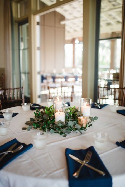 a lovely modern nautical wedding tablescape with a white tablecloth and navy napkins, candles with greenery for a centerpiece Oyster Bay Yacht Club Wedding, Yacht Club Wedding Decor, Nautical Wedding Table Decor, Yacht Wedding Decor, Boat Wedding Decorations, Yacht Decorating Ideas, Yacht Wedding Ideas, Modern Nautical Wedding, Centerpiece With Greenery