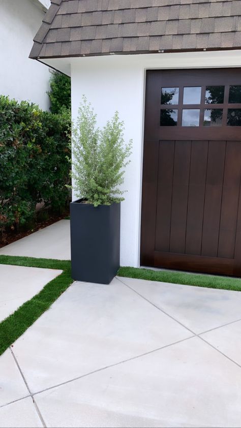 New irrigated planter and walnut garage door coffee stain Planters Outside Garage, Plants By Garage Door, Planter By Garage Door, Potted Plants By Garage Doors, Garage Door Flower Planters, Garage Outdoor Decor, Potted Plants In Front Of Garage, Planters Between Garage Doors, Front Garage Landscaping