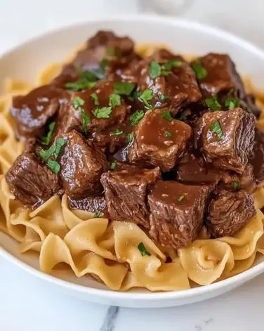 Crockpot Beef Tips & Noodles: tender beef, rich gravy, and egg noodles. Perfect for busy days. Try this easy recipe today! Beef Tips Noodles, Noodles Crockpot, Beef And Noodles Crockpot, Crockpot Beef Tips, Beef Tips And Noodles, Beef Tips And Gravy, Lipton Onion Soup Mix, Beef Pasta, Cheap Healthy