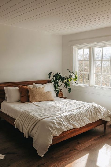 Create a peaceful minimalist bedroom by embracing clean lines, neutral colors, and smart storage solutions. Opt for simple furniture with hidden storage to keep the space clutter-free. Add warmth with natural wood tones and soft textiles for a calming atmosphere. 🛏🌿 Primary Bedroom Minimalist, Small Calm Bedroom, Minimal Natural Bedroom, Simple Neutral Bedroom Decor, Clean Bedroom Inspiration, Airy Bedroom Aesthetic, Bedroom White And Wood, Minimalist Master Bedrooms Decor, Simple Clean Bedroom