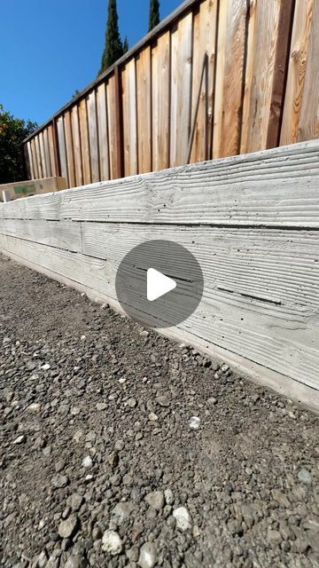 Flor Landscaping on Instagram: "In need of a retaining wall? Check this one out 🤩  Here we’re showcasing a custom, stunning wood board finish concrete wall, beautifully showing wood grain in the concrete. If you’re considering a new retaining wall, this option can be game changer!  . . . . . #retainingwalls #concretemasonry #concrete #hardscapeartist #hardscaping #sanjose #wooddesign" Retainer Walls Landscape, Retaining Wall By Fence, Fence On Retaining Wall Ideas, Cinderblock Retaining Walls, Diy Concrete Retaining Wall, Retaing Wall Ideas Diy Concrete, Concrete Retaining Wall Ideas, Retainer Wall Ideas, Driveway Upgrade