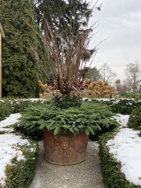 garden sculpture | Deborah Silver & Co. Yellow Twig Dogwood, Winter Planters, Red Twig Dogwood, Evergreen Landscape, Deborah Silver, Twig Dogwood, Plastic Grass, Dogwood Branches, Winter Planter