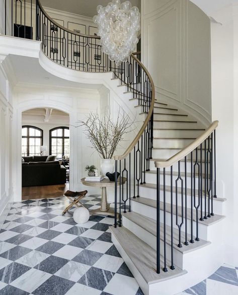 In awe of this timeless hallway; those monochrome marble piano tiles are just 🫶🏼🫶🏼🫶🏼      📸credit:  Designed by @noblestudio_interiors Constructed by @kennonconstruction Photographer @juliawade Styling: @gthr.d 👏🏼🫶🏼 ___________________  Follow @britishhomedesign for daily inspiration.  • BHD is a multi-award winning, Norfolk based, Architecture & Interior Design Studio tagging inspirational home design with our label of approval • ___________________ Curved Staircase Foyer, Talia Chandelier, Foyer Renovation, Marble Staircase, Stair Rail, Stairway Design, Grand Foyer, Curved Staircase, Glass Balls