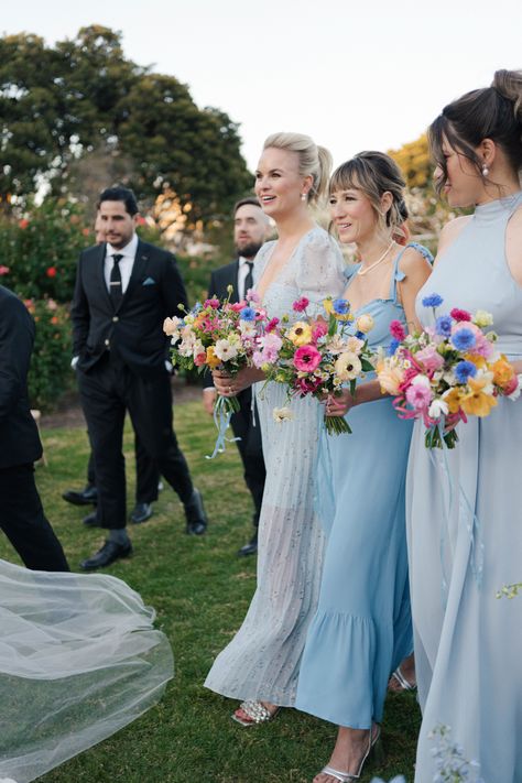 Kelsey & William's wedding at the Natural History Museum. Her bridesmaids were her "something blue" with their wildflower-inspired bouquets by Tularosa Flowers Colorful Lake Wedding, Dusty Blue Wedding With Wildflowers, Blue And Wildflower Wedding, Pink Yellow Blue Wedding Bridesmaid Dresses, Ice Blue Bridal Party, Wildflower Bridesmaids Bouquet, Wildflower Wedding Bridesmaid Dresses, Bridesmaids With Colorful Bouquets, Light Blue Wedding With Colorful Flowers