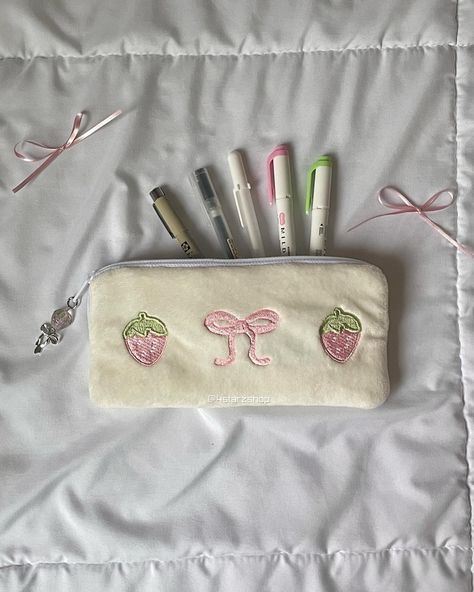 Our Bowberry plush zipper pouch features embroidered pink bows and strawberries. It doubles as a pencil case for holding your highlighters and pens or a pouch to hold your glasses! It comes lined and has a matching strawberry and bow beaded charm. Measurements: ☆ Width: 7.75  inches ☆ Height: 3.75 inches ☆ Depth: 0.75 inch Whats In My Pencil Case List, Y2k Pencil Case, Coquette Pencil Case, Pencil Case Essentials, Crochet Pencil Pouch, Cute Pencil Cases, Pencil Case Aesthetic, Pink Pencil Case, Crochet Pencil Case