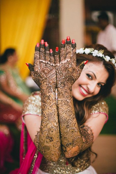 Photo of Bride showing off traditional bridal mehendi Mehendi Photography Bridal, Mehendi Photoshoot, Bridal Mehendi Designs Wedding, विवाह की फोटोग्राफी की मुद्राएं, विवाह की दुल्हन, Mehendi Photography, शादी की तस्वीरें, Indian Bride Poses, Indian Bride Photography Poses