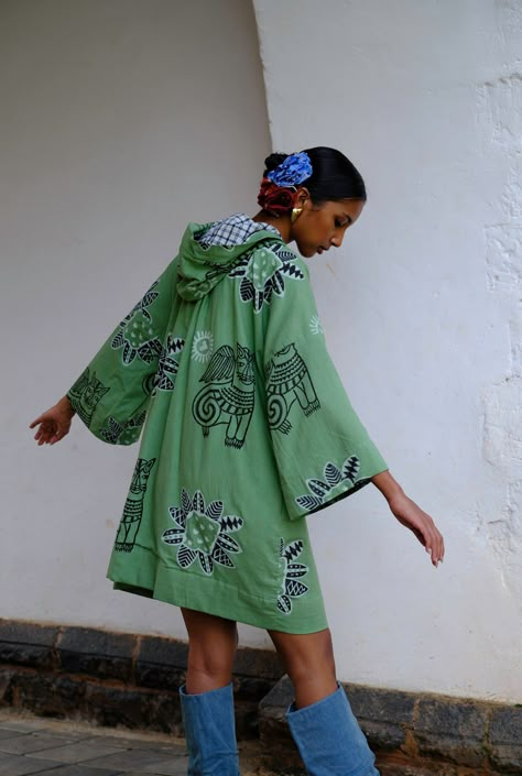 This mini dress is brought to life with our eclectic JODI hand block printed motifs. Crafted in cotton, it has a relaxed shape and a hood detail with checks. Look closely and you will see a cutesy bead hand embroidery detail too. We believe you have a right to know how this product was made. 3 meters of south Indian mangalgiri cotton fabric sourced from Jaipur has been used for this piece. Hand printed by our artisans in Jaipur, manufactured in our workshop at Pune, India. If you wish to have th Block Print Outfits Street Styles, Hand Block Printed Fabrics, Eclectic Dresses, Indian Block Print Motifs, Wrap Waist Dress, Indian Lifestyle, Indian Block Print Fabric, Mens Outerwear Fashion, Block Print Dress