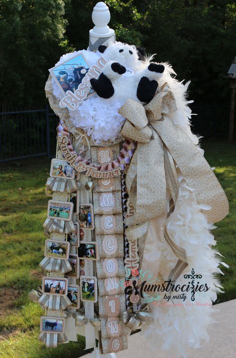 Homecoming Mum:  Senior, Cow Theme, Mega Deluxe, Unique and big! White, light and rose gold.  Custom hand-dyed boas https://www.mumstrocitiesbymisty.com/ https://www.facebook.com/mumstrocitiesbymisty/ Homecoming Mum With Pictures, Cow Mums Homecoming, Senior Mum Ideas Homecoming, Big Mums Homecoming, Senior Mums Homecoming White And Gold, Senior Mums Homecoming White, Senior Mum Ideas, Homecoming Mums Ideas Unique, Big Mum