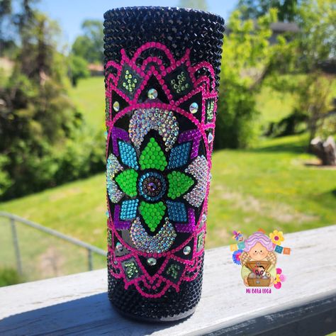 Indulge in the beauty of our handcrafted Neon Mandala Rhinestone Tumbler. With a stunning mix of black, neon, and crystal rhinestones, this 20-ounce tumbler is not only beautiful but also practical. Each rhinestone is meticulously placed in a one-of-a-kind design, making it a unique piece from our small shop. Perfect for those with a boho or retro 70's style, this tumbler is a must-have for any mandala lover. Whether you're sipping on your favorite iced coffee, spring water, or iced tea, this tumbler is sure to turn heads and make you the envy of everyone around. To maintain the brilliance of your rhinestone tumbler, please ensure you follow these care instructions: Hand wash ONLY; this tumbler is NOT dishwasher safe Avoid soaking as it may loosen and displace the rhinestones Do not expose Gem Cups, Rhinestones Tumbler, Neon Mandala, Bling Cups, Rhinestone Tumblers, Rhinestone Patterns, Rhinestone Designs Pattern, Rhinestone Tumbler, Rhinestone Cups