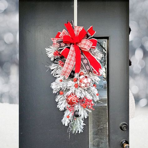 White heavily flocked swag with large red and white ornaments, red bells and small black ornaments. This swag is beautiful with it's contrasting colors of black, white and red. Black stemmed berry picks add that little bit of color to this white swag. Topped off with a fun bow this swag is a beautiful piece to add to your holiday decor.  approximate size 30 x 13 x 7 Wreath is shown on a 36 inch door Some of my wreaths are one of a kind those I can't remake. If it says one of a kind in the descri Red And White Christmas Door Garland, Dollar Tree Christmas Swags Diy, Christmas Swags Ideas, Red And White Ornaments, Flocked Wreath, Grinch Ideas, Black Ornaments, Swag Christmas, Teardrop Swag