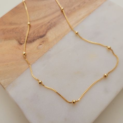 Description Gold Beaded Chain Gold Filled Beaded Necklace, Gold Choker Necklace, Gold Satellite Chain, Dew Drops Necklace, Minimalist Necklace 💖 DETAILS ⋆ 18k Gold Filled ⋆14 Inch * 16 Inch *18 lnch ⋆ Adjustable ⋆ Nickel-free and hypoallergenic 💖 GENERAL DESCRIPTION Keep it simple with this small beaded choker necklace and no doubt it will become a jewelry box essential. Adjust the length for a different feel each day and keep your look cool and effortless by teaming with longer and bolder sty Drops Necklace, Choker Necklace Gold, Fine Gold Necklace, Gold Jewelry Outfits, Gold Earrings Models, Beaded Necklace Designs, Gold Pendant Jewelry, Black Beaded Jewelry, Wedding Jewellery Collection