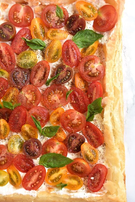 Tomato Basil Feta Tart features a flaky puff pastry tart with a whipped feta spread, the most flavorful tomatoes and fresh basil leaves for a tasty appetizer or side dish! www.nutritionistreviews.com #tomato #tomatoes #feta #basil #tart #appetizer #sidedish #vegetarian Tart Appetizer, Feta Spread, Feta Tart, Feta Pizza, Tomato Mozzarella Basil, Greek Appetizers, Puff Pastry Crust, Pizza Appetizers, Puff Pastry Tart