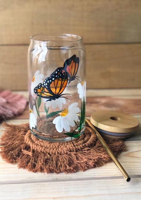 For more options, visit our website www.cariyanandco.shop ♡ Hand painted Libbey glass cup. Painted with durable glass paint. Please note that all glasses are handcrafted, make each glass unique. ☕️ Perfectly unique gifting idea for coffee lovers! ☕️ This listing has the option of one glass cup with lid (includes lid and straw) This item cannot be rushed. Processing time is 3-5 days before shipping. After processing it is 2-4 day shipping with USPS ♡ 16-ounce classic can glasses (3-inch diameter Butterfly On Glass Painting, Daisy Painted Wine Glasses, Draw On Glass Cups, Butterfly Painted Wine Glasses, Butterfly Glass Cup, Painting On Glass Cups, Drawing On Glass Cups, Painting Glass Cups, Butterfly Glass Painting