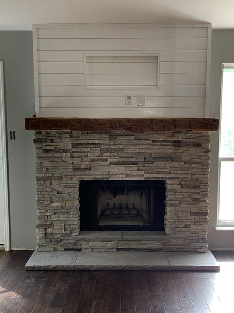 We updated our fireplace surround, removed old brick and installed new stacked stone, mantle, hearth, shiplap and electric for TV. Shiplap Fireplace With Stone Surround, Fireplace Stone Floor, Stone Fireplace And Mantle Ideas, Shiplap Wall With Stone Fireplace, Fireplace With Stacked Stone, Shiplap And Brick Wall, Stone Gas Fireplace With Tv Above, Fireplace Stacked Stone Ideas, Gas Fireplace Hearth