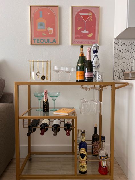 Good bar cart inspired for a small area. Cute color wall art. Fun glasses from cb2. Wine bottles. Wine glasses. Cheap Bar Cart Ideas, Simple Bar Cart Ideas, Cute Bar Set Up, College Bar Cart Ideas, Bar Cart Inspo College, Bar Cart With Fridge, Bar Ideas Apartment, Bar Cart Corner, Cheap Bar Cart