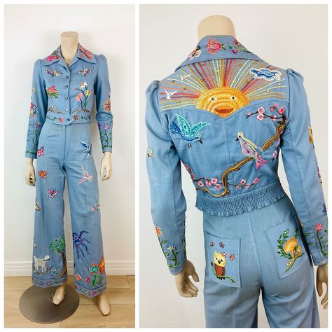 Vintage 1970s Embroidered Denim Jacket & Pants Set total work of art! hand made & hand embroidered! set includes  jacket & bellbottom pants made of light blue cotton denim material heavily embroidered with whimsical creatures jacket has button closures at front puff shoulder fits at waist high waisted pants bell bottom leg covered in colorful embroidered sun with rays, birds, flowers, apple tree, giraffe, octopus, mermaid, cherry blossoms, scorpion, skunk, lamb in French knot, butterflies and co Vintage School Outfits, Bellbottom Pants Outfits, Funky Suits, Denim Pantsuit, Nudie Suit, Whimsical Clothing, Octopus Mermaid, Bellbottom Pants, Whimsical Creatures