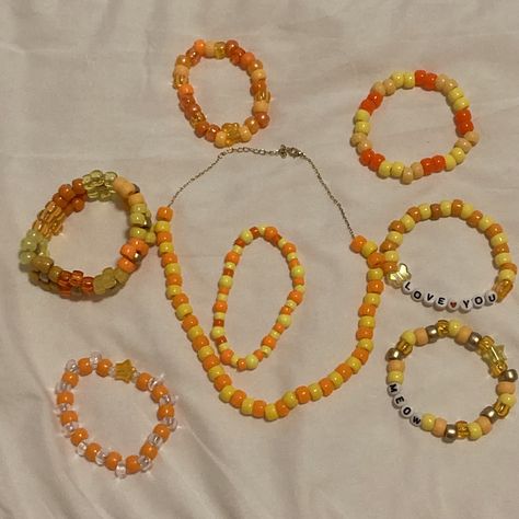 Various orange and yellow kandi bracelets and necklace Yellow Kandi Bracelets, Kandi Flower, Kandi Necklace, Orange Bracelet, Kandi Bracelets, Orange And Yellow, Green And Orange, Jewelry Ideas, Craft Ideas