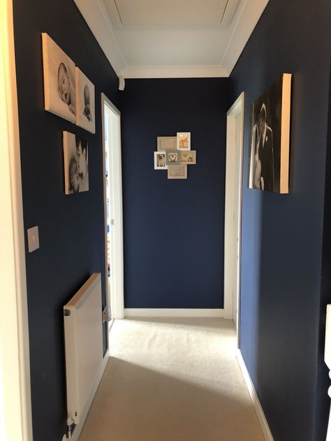 Finished hallway, navy walls, white woodwork, canvas prints Blue Walls Staircase, Painted Door Frames Hallway, Hallway Blue Walls, Navy And White Hallway, Hallway Inspiration Small, Navy Hallway Ideas, Blue Hallway Paint, Blue Hallways, Dark Blue Hallway