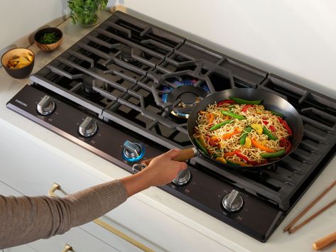 This Samsung Gas Cooktop offers a full range of burners for all of your cooking needs. Its 22K BTU true dual-power burner with two heat options quickly boils water or maintains a simmer. Use the griddle to cook breakfast foods, grill sandwiches or sauté vegetables. Easily accommodate a round bottom wok on the custom wok grate. Blue LED illuminated knobs visually let you know your cooktop is on even at a distance. Cook Top Stove, Gas Stove Top, Single Wall Oven, Portable Washer, Gas Hob, Outdoor Refrigerator, Grilled Sandwich, Upright Freezer, Gas Cooktop