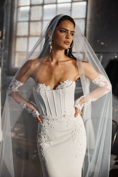 Our Hale corset wedding dress blends light ivory crepe with botanical lace for a stunning look. Featuring detachable cold-shoulder lace sleeves for arm coverage, the corset with half-cup lace detail and exposed boning ensures a perfect fit. The fitted crepe skirt and lace placement highlight your natural curves, while the back boasts an illusion panel and crepe-covered buttons extending to the lace train. For added drama, pair with the matching Hale veil. Wedding gown available in sizes 2-28. Strapless Corset Wedding Dress, Bridal Showroom, Corset Wedding Dress, Wedding Dresses Corset, Strapless Corset, Light Ivory, Bridal Suite, Luxury Bridal, Perfect Wedding Dress