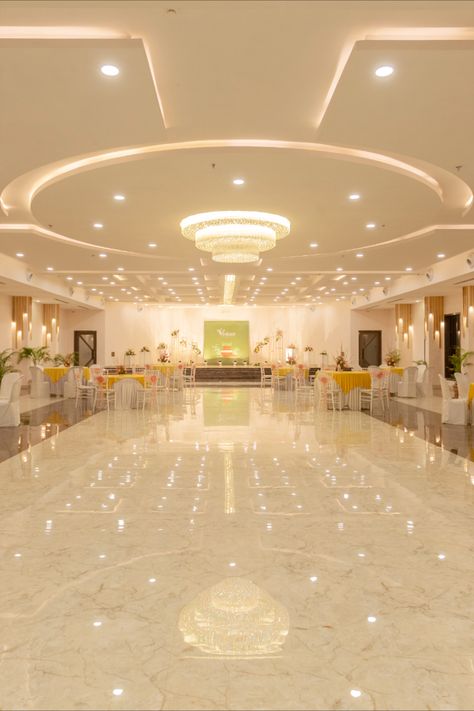 The Main entrance opens up to a grand banquet hall which is a dedicated ritual area for Indian ceremonies, a pillar-free ballroom with a 14 ft high ceiling for the perfect wedding ambience. The interiors of the main hall were designed around the ceiling. Banquet Hall Floor Tiles Design, Birthday Party Hall Interior Design, Wedding Halls Designs, Wedding Hall Background, Marriage Hall Ceiling Design, Wedding Hall Design Interior, Wedding Hall Ceiling Design, Banquet Hall False Ceiling Design, Event Interior Design