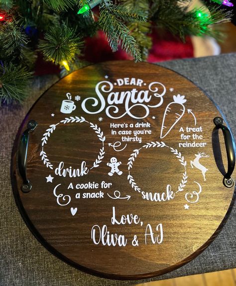 "Add a touch of magic to your Christmas Eve with our personalized round reindeer carrots milk cookie for Santa tray. This charming wood board doubles as a serving tray and a delightful Christmas cookie treat display. The tray features a festive design with black metal handles, perfect for carrying and showcasing your favorite treats. Choose from two sizes: the 15\" tray measuring 15\" round x 1\" thick (3\" with handles) or the 18\" tray measuring 18\" round x 1\" thick (3\" with handles). Get ready to impress Santa and create unforgettable memories with this enchanting tray. Handmade and finished in your choice of paint or stain then sealed with a polyacrylic finish for durability.  Trays are personalized with your child's name in white permanent vinyl." Santa Cookies Tray, Treats For Santa Tray, Santa Tray Wood, Santa Trays, Santa Cookie Tray, Milk Tray, Round Wooden Tray, Red Mahogany Stain, Santa Tray