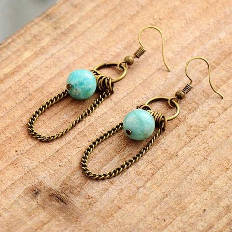 Pale blue-green Amazonite beads drop delicately between metallic hoop embellishments, giving these earrings a lovely fluid movement. Our Delphine Earrings are handcrafted and beautifully statement making. Carefully packed in a gift box  and delivered within 3 working days. - Amazonite natural stone - Brass - Drop 7 cm / 2.8 inches (including ear wire) - Handcrafted All our natural stone jewellery is crafted by hand, with natural materials, making each piece 'one of a kind' and beautifully unique Semi Precious Stone Jewelry, Optimum Health, Amazonite Earrings, Green Amazonite, Rustic Earrings, Hippy Chic, Natural Stone Earrings, Amazonite Stone, Bead Ideas