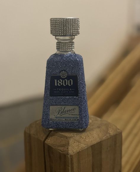 This 50ml bottle of 1800 is a real showstopper! It's dressed up in a stunning ocean blue with shimmering glitter that catches the light just right. The sparkling finish gives it a fun, festive vibe that makes it perfect for any celebration or just adding a bit of flair to your collection. It's not just tequila; it's a piece of eye candy! Decorated Bottles For 21st Men, Navy Quince, Blinged Bottles, Alcohol Bottle Decorations, Bedazzled Liquor Bottles, Alcohol Bottle Crafts, Decorated Liquor Bottles, Bottle Decorations, Alcohol Bottles